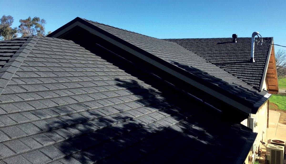 Picture of a  new Tilcor Armored Roof install in Ohio. You can the Newly installed armored Shingles with the afternoon sky in the background. 