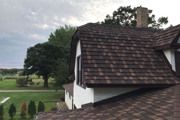 Picture of a Dayton Ohio residential  home. You can see a newly installed roof with brown asphalt shingles.
